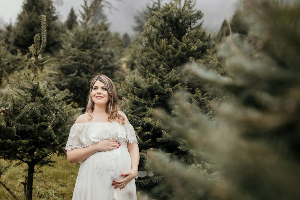 Mujer entre el bosque en sus fotos de embarazo en Finca El Espinero.